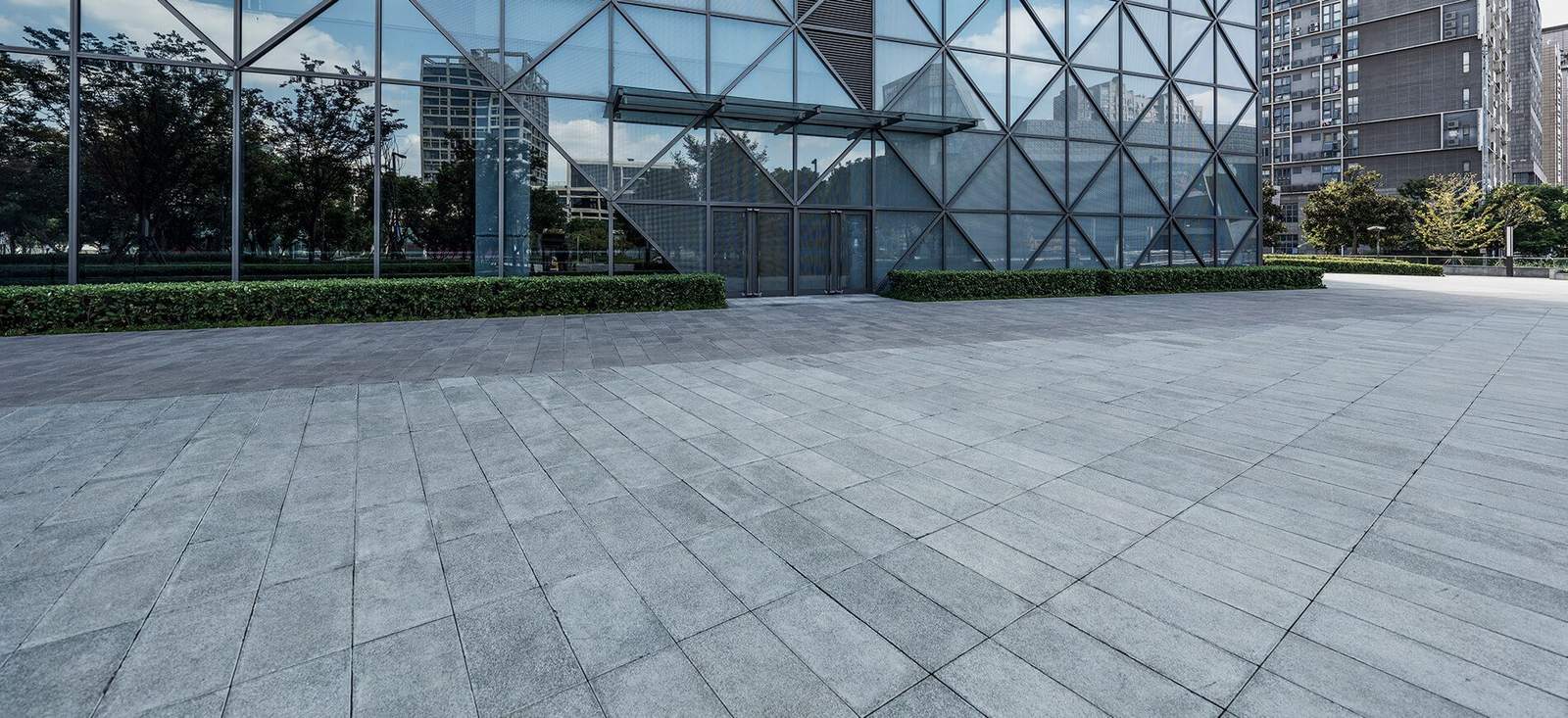 glass building in big city reflecting other buildings