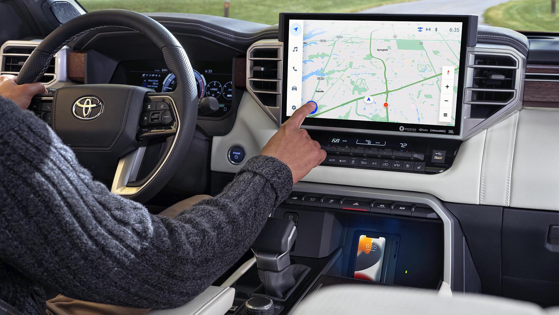 man in Toyota Sequoia using touch screen navigation