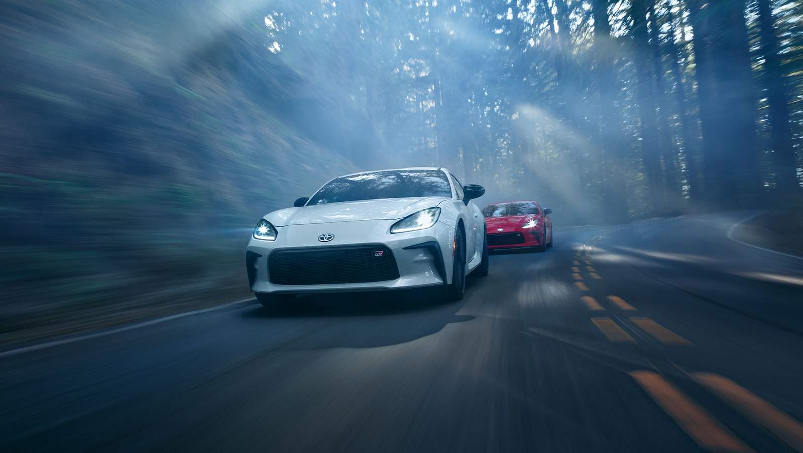 2024 Toyota GR86 driving down a forrest road