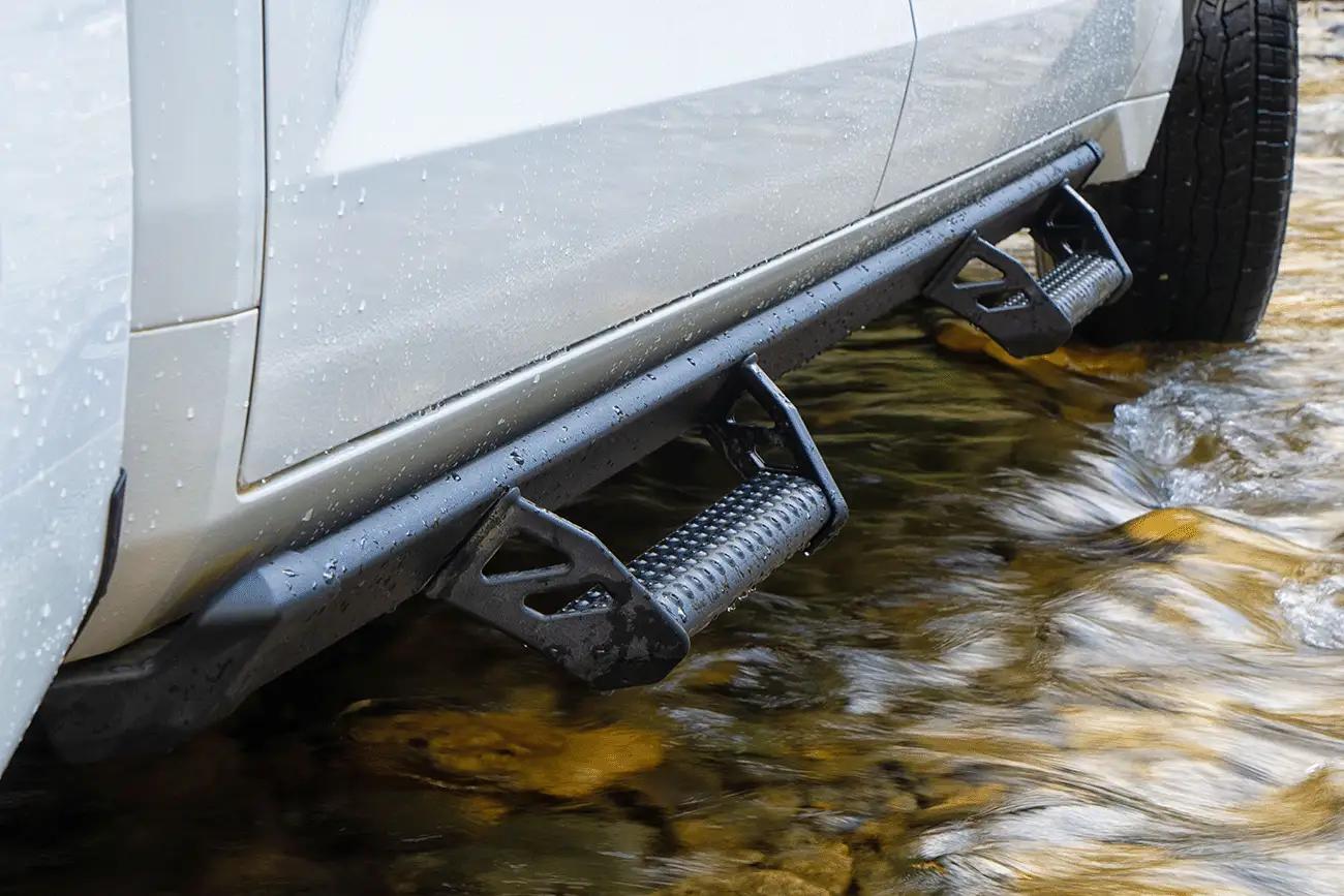 close up of the side of a white 2022 Toyota Tundra XP XSeries upgraded accessory package showing the XSeries Predator running board with drop step