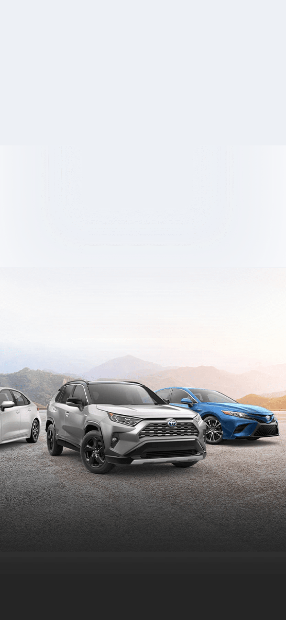 Toyota vehicle lineup in front of mountains
