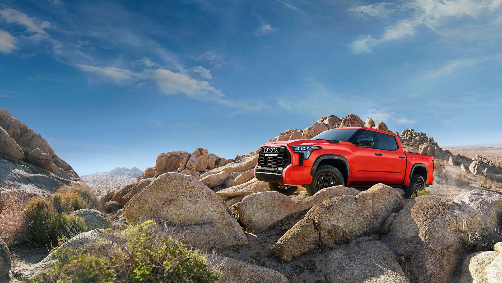 Orange Toyota Tundra on rocky mountain