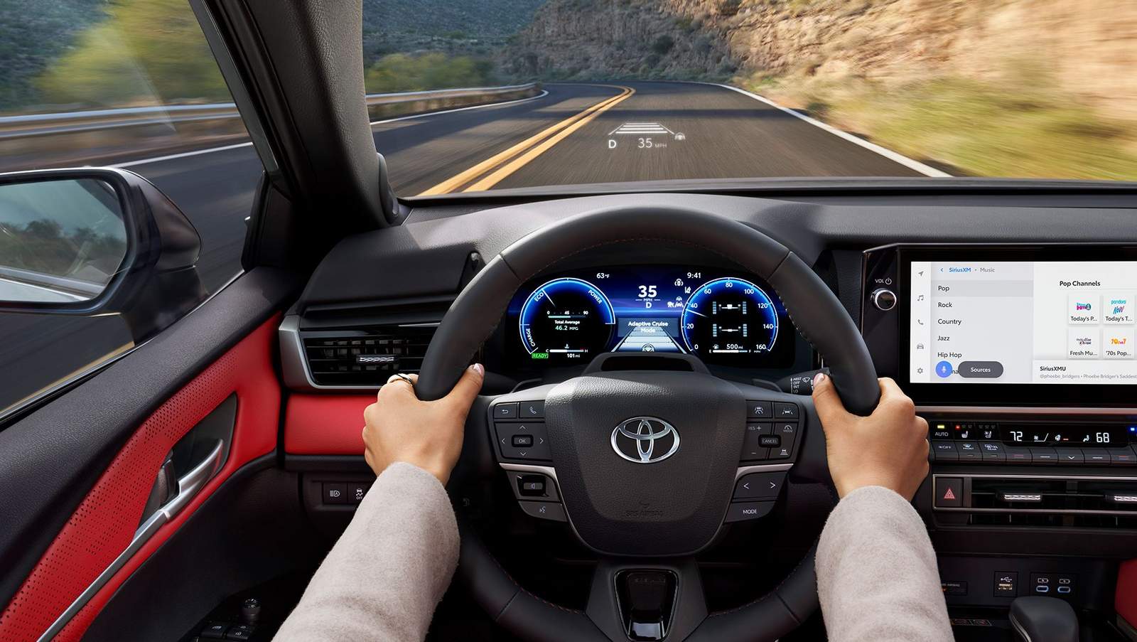 2025 Toyota camry inside image showing the blue illuminated dashboard and heads up display where the speed and other info is displayed right onto the bottom of the windshield