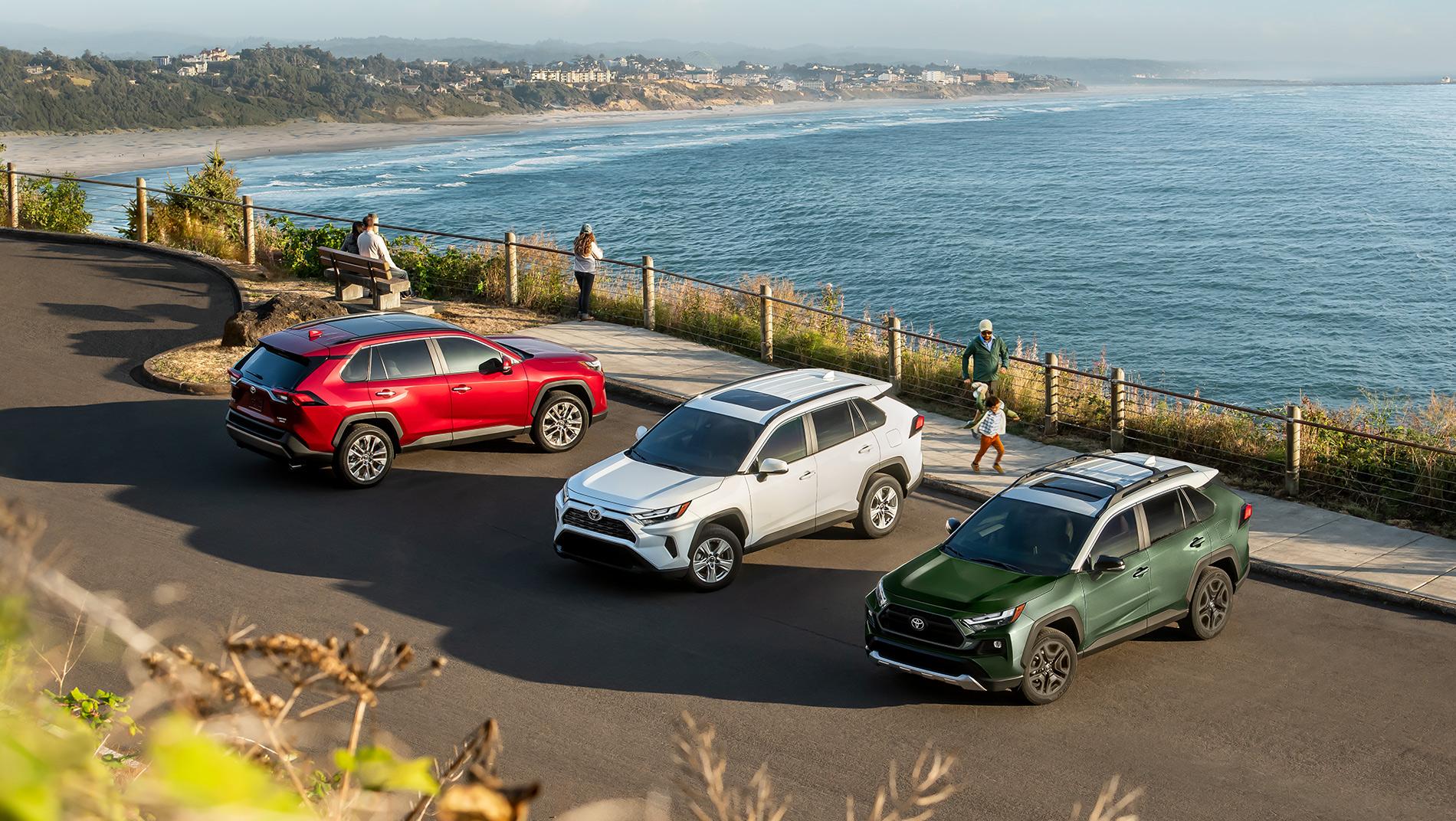 Toyota SUV Vehicle lineup in a parking log overlooking a beach and the ocean