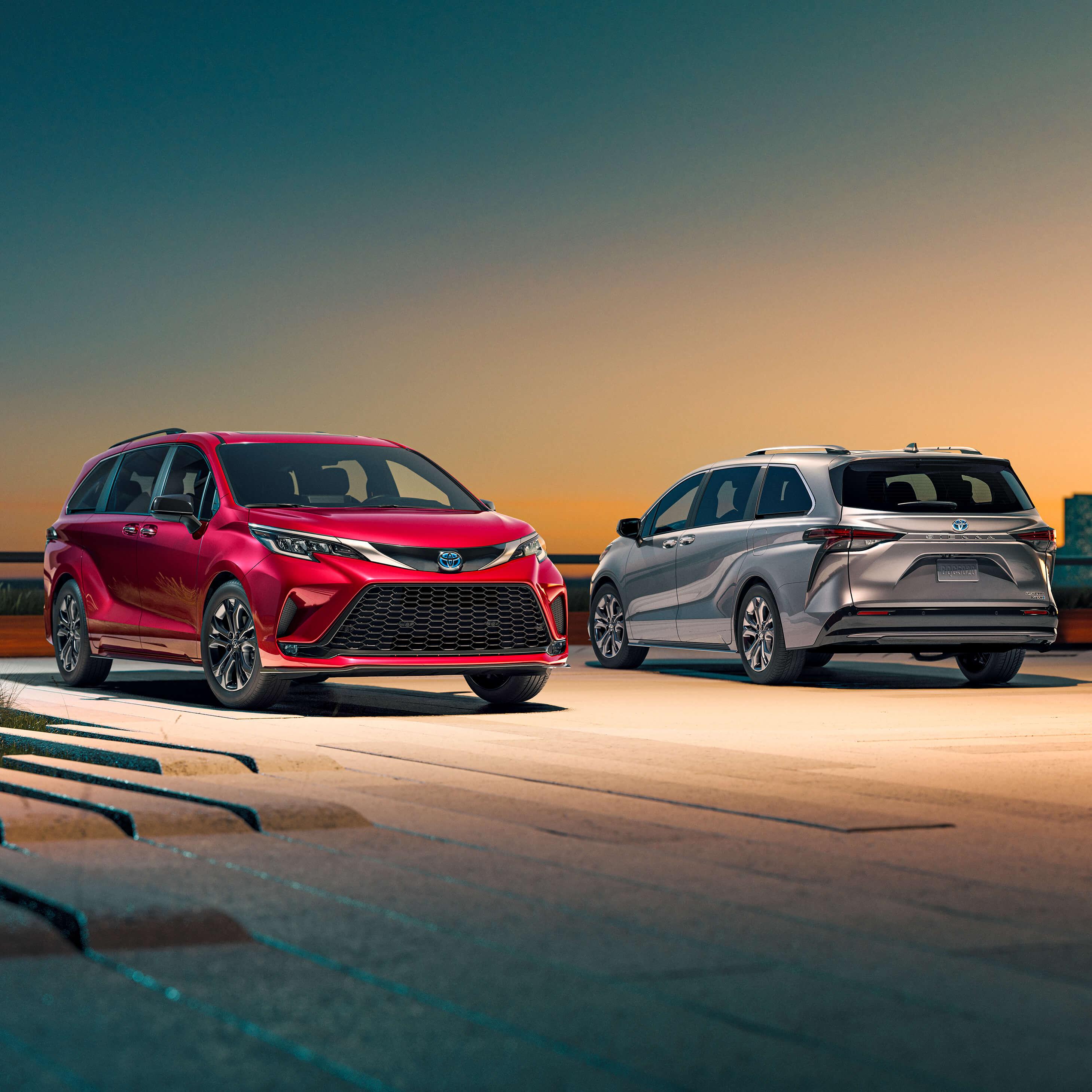 w Toyota Sienna minivans parked on a rooftop deck at sunset