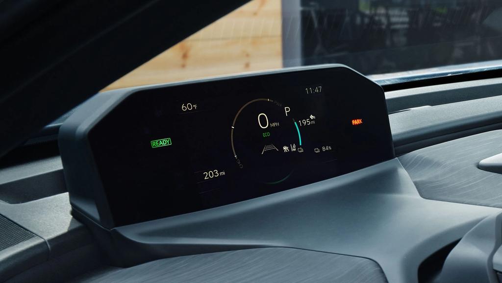 Close-up view of a digital dashboard display in a modern vehicle showing speed, gear in park, temperature, battery range, lane assist, and various indicator lights on a sleek, minimalist panel.