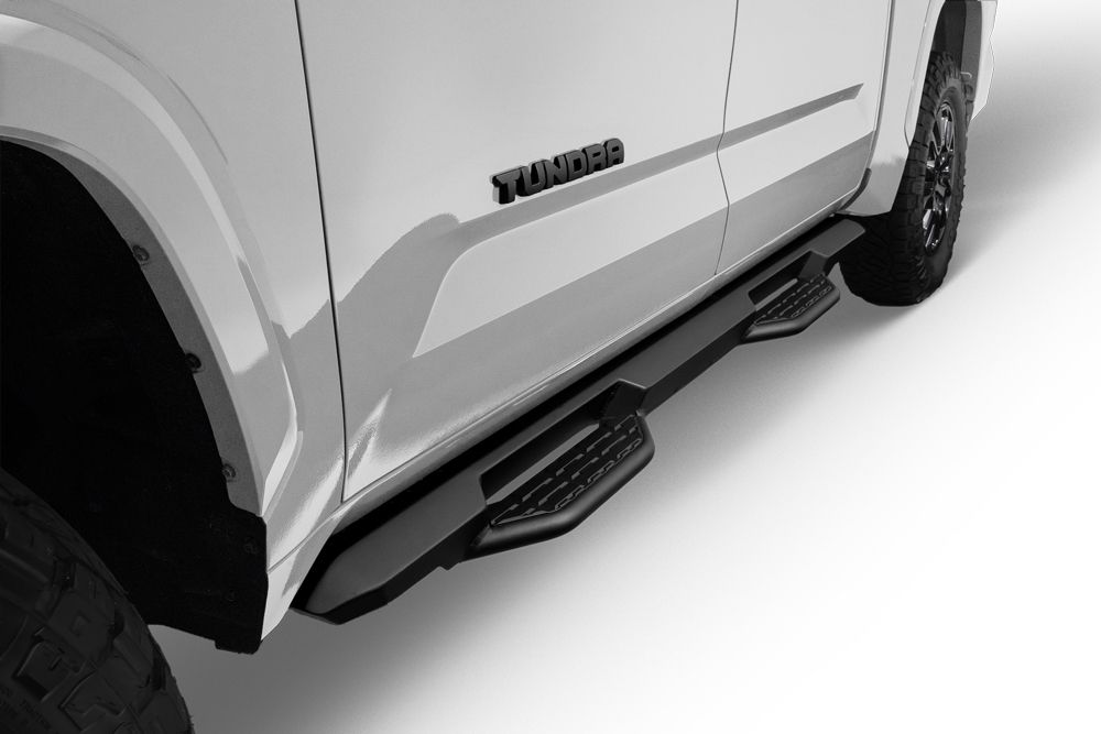 Exterior view of a Toyota Tundra XSP Shadow I-FORCE MAX Hybrid HEV. Showing off its prominent front grille and four doors.