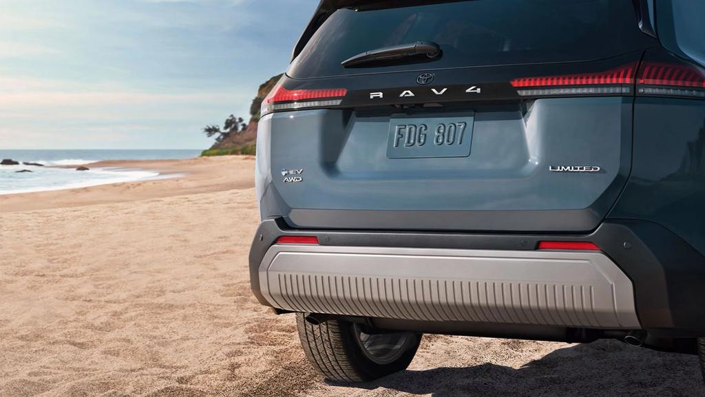 Toyota I-FORCE MAX Hybrid HEV Tundra or Tacoma demonstrating towing and hauling capability with a large load in the bed