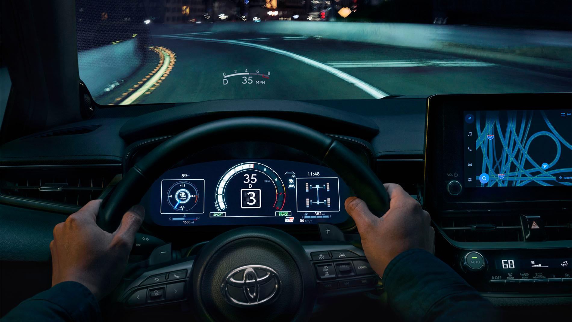 An image of the dashboard and steering wheel where you can see your speed projected on the window in front of you. This is featured in the 2025 toyota gr corolla.