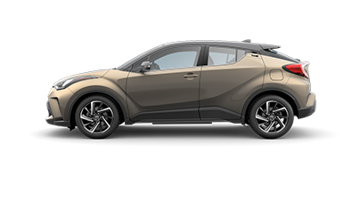 Side view of a brown compact 2021 toyota chr SUV with black roof, sharp lines, and sporty alloy wheels