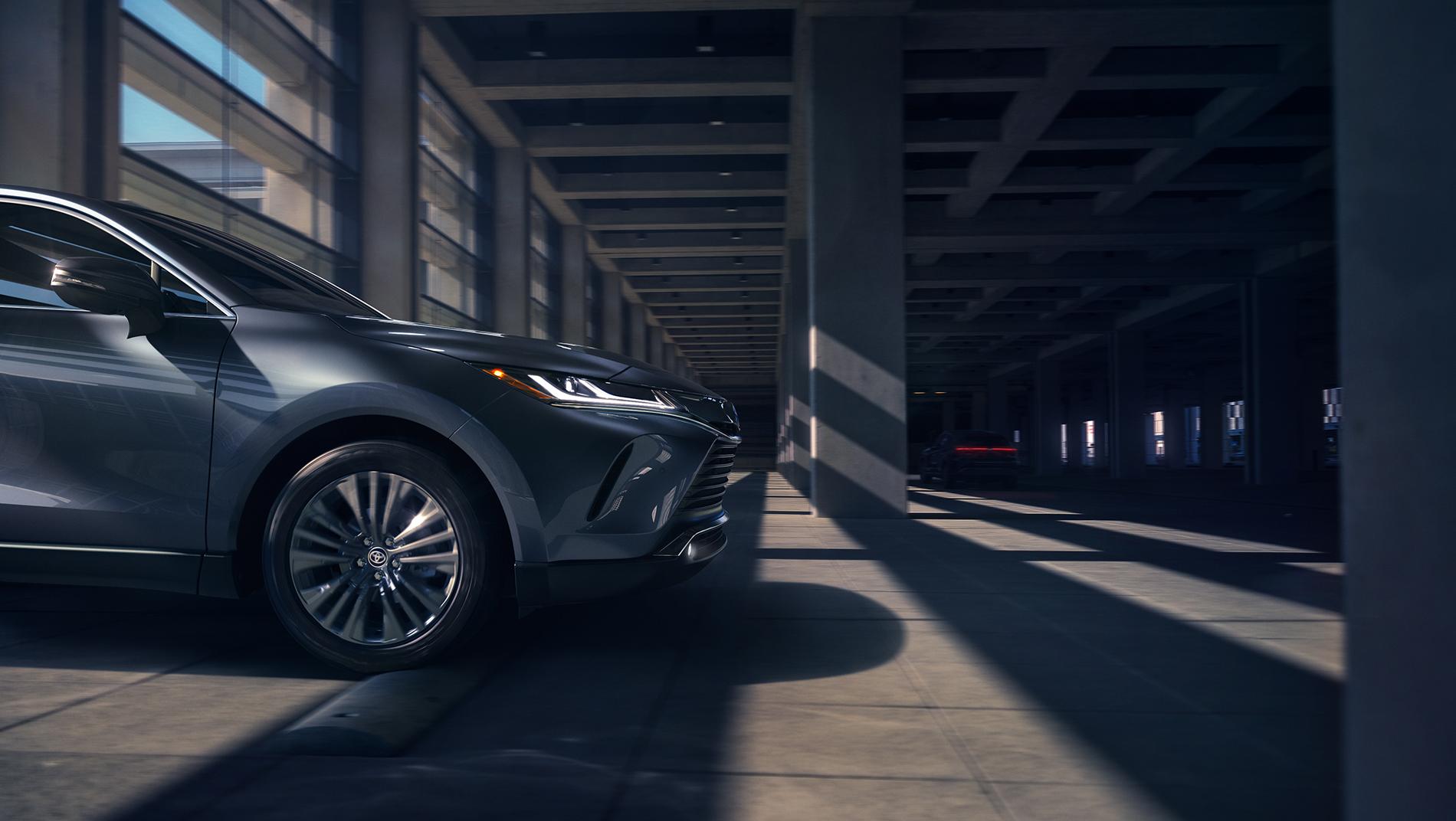 front end of a grey Toyota Venza driving under a parking deck