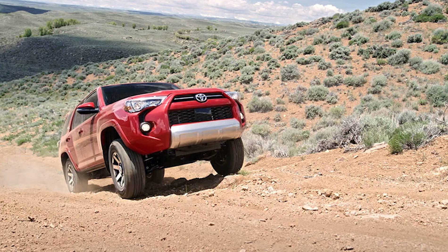 red Toyota 4Runner front shot of climbing up a mountain