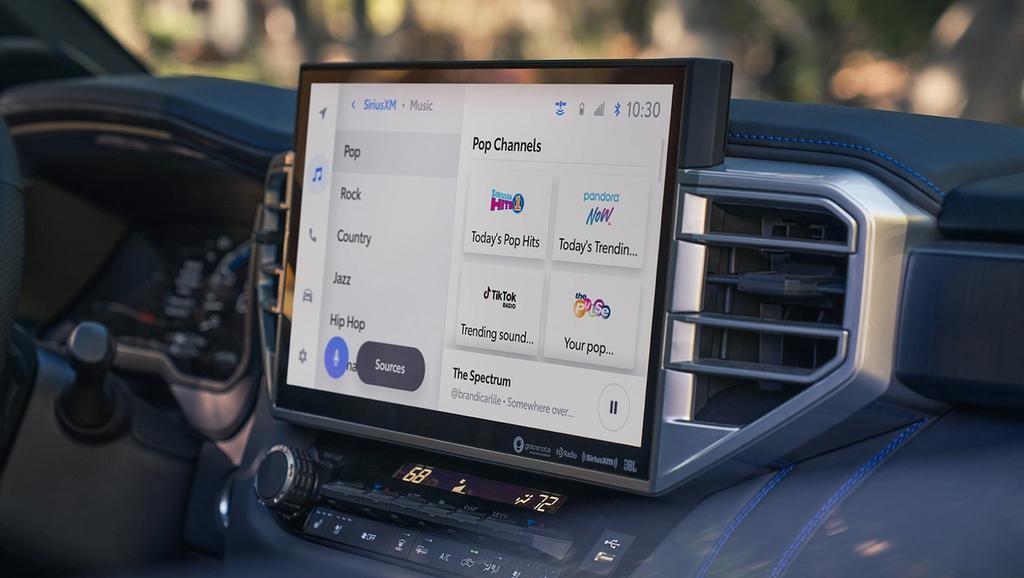 The interior of a toyota tundra featuring a large touchscreen display with navigation