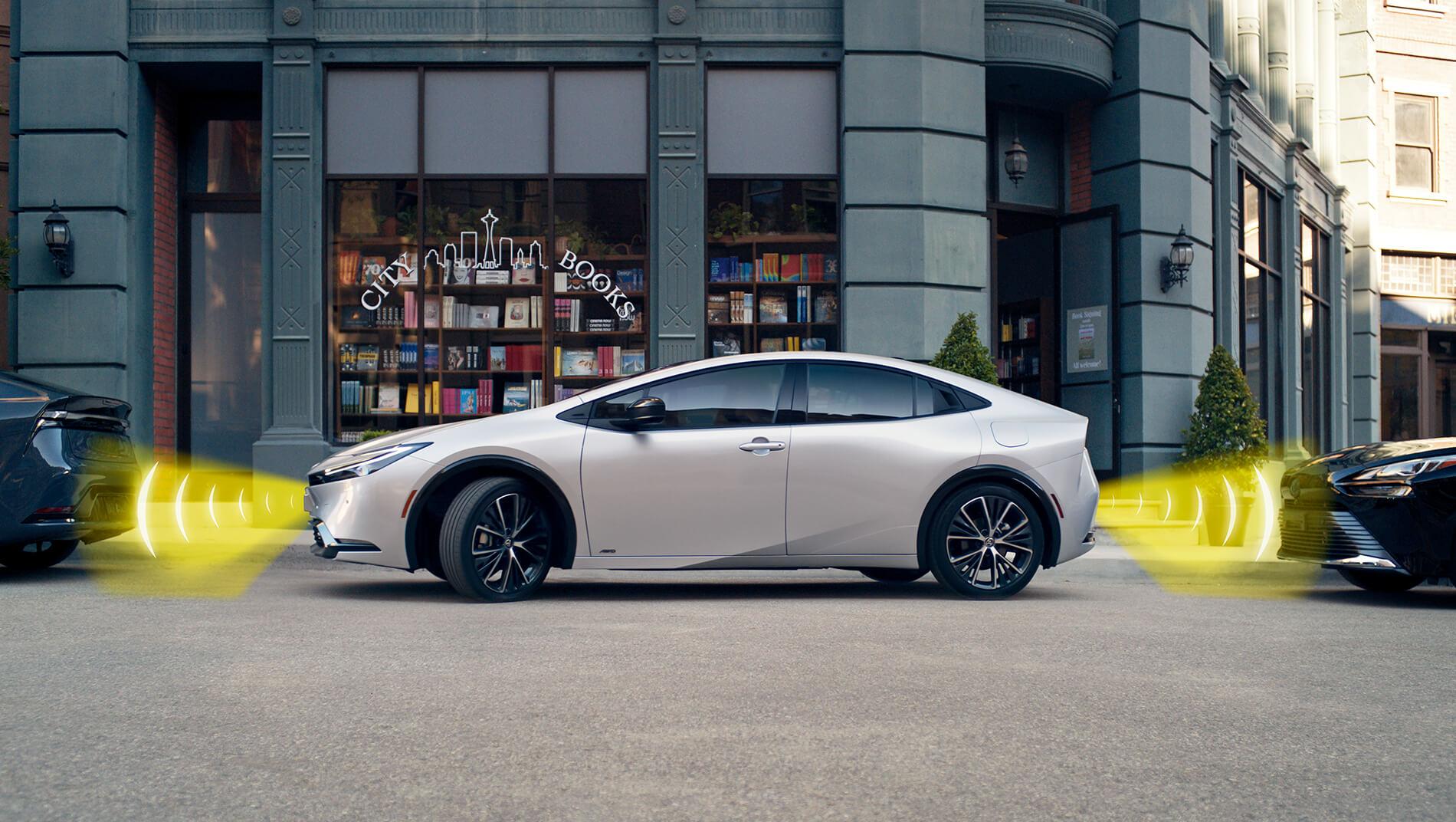 2023 Toyota Prius Parking assist working in front a a city book store