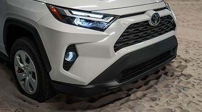 Front zoomed in view of a white 2024 toyota rav4 hybrid.