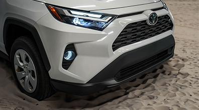 Front zoomed in view of a white 2024 toyota rav4 hybrid.