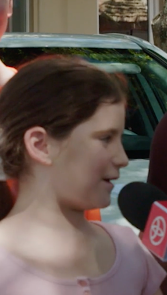 Toyota microphone in front of young girl standing in front of 2 teenagers