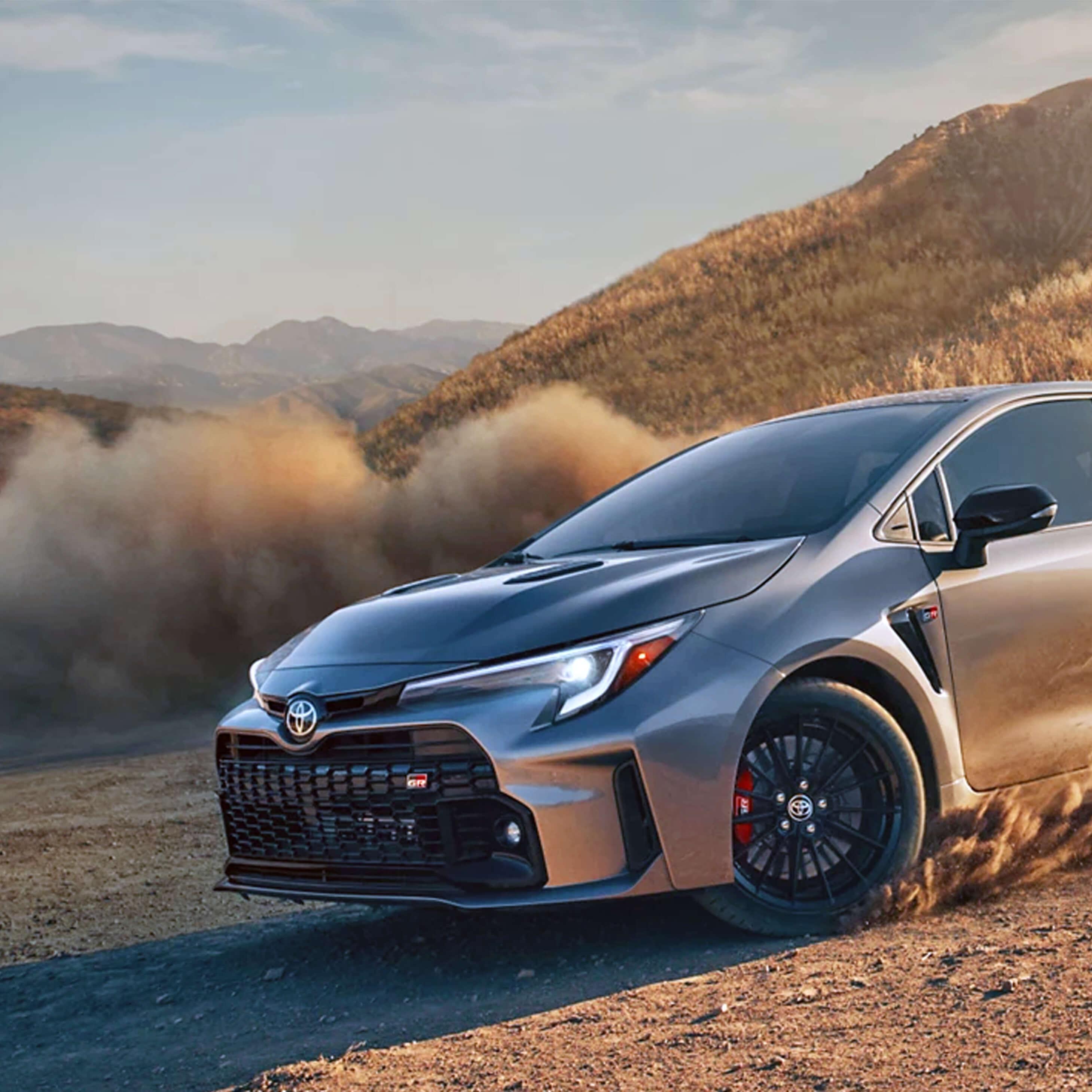 2023 Toyota GR Corolla driving down dusty mountain road