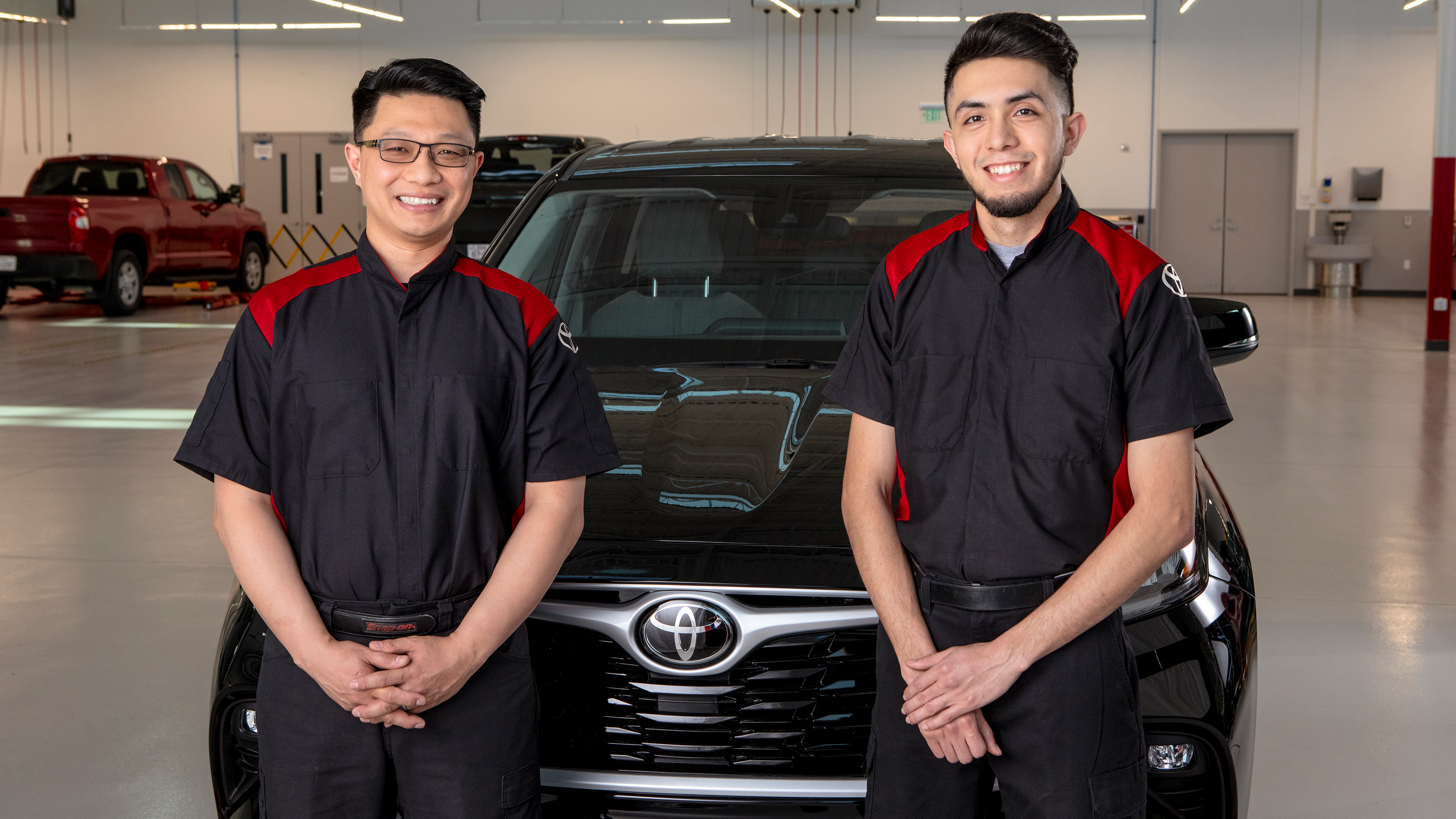 2 Toyota Certified Technicians in a Toyota Service bay