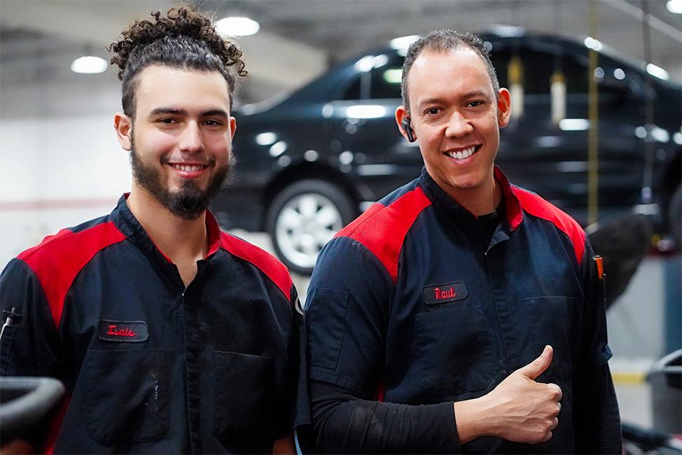2 male Toyota Certified Technicians in service bay