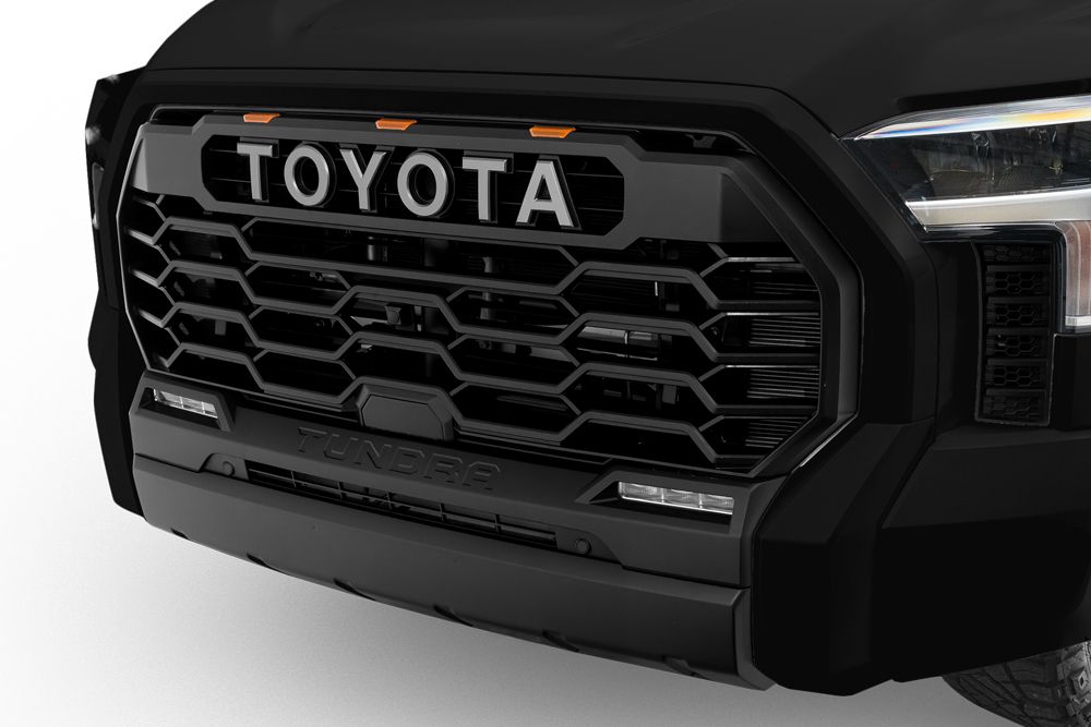 Exterior view of a Toyota Tundra XSP Shadow I-FORCE MAX Hybrid HEV. Showing off its prominent front grille and four doors.