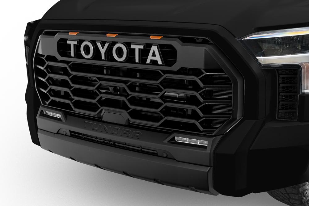 Exterior view of a Toyota Tundra XSP Shadow I-FORCE MAX Hybrid HEV. Showing off its prominent front grille and four doors.