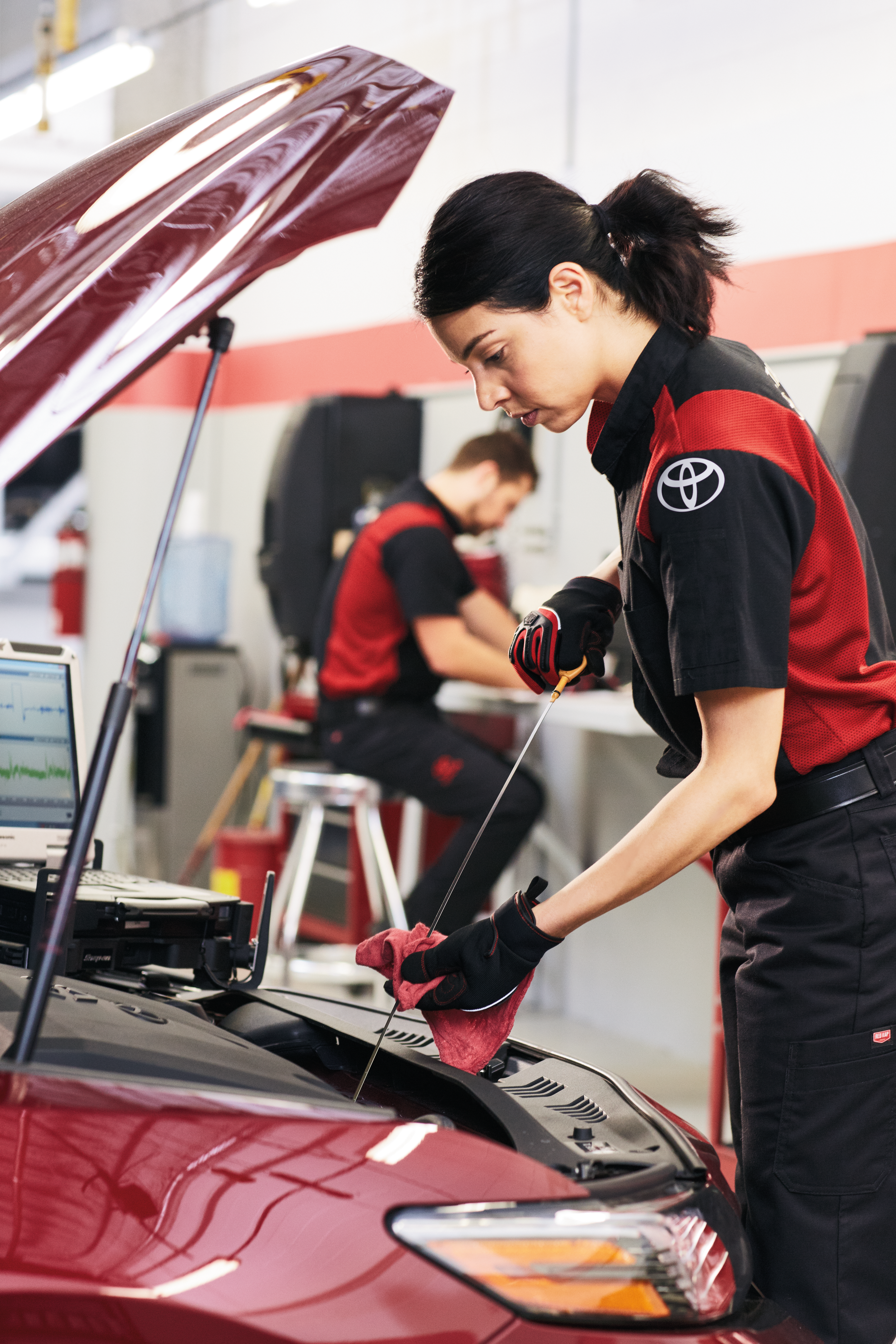 Toyota certified female technician changing oil