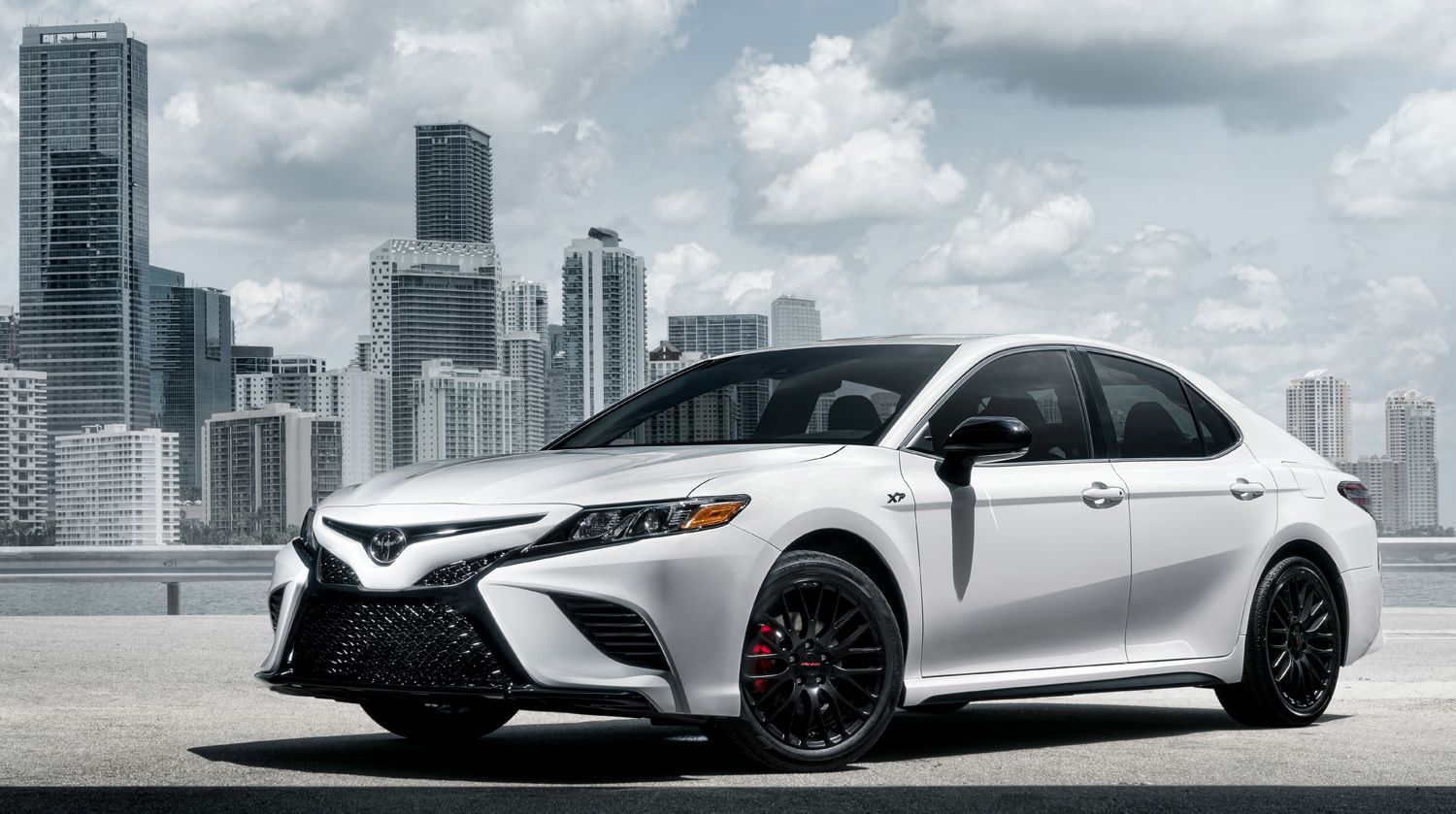 2024 Toyota Sedan sitting on a roof top in the city with sky scrapers behind you