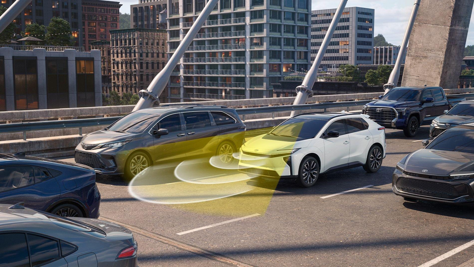 A white toyota bZ on a bridge uses yellow radar waves to sense a gray minivan beside it, illustrating an advanced driver assistance system.