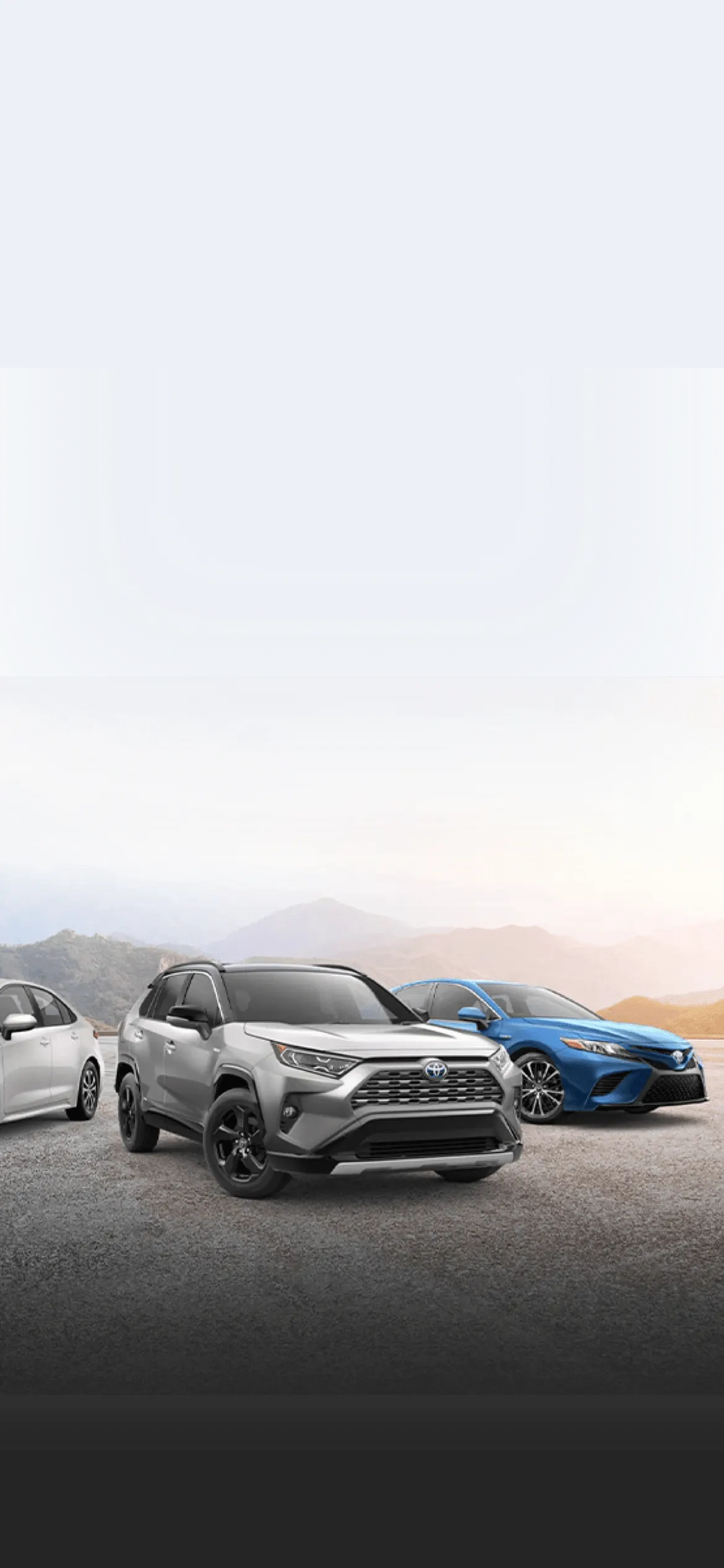 Toyota vehicle lineup in front of mountains