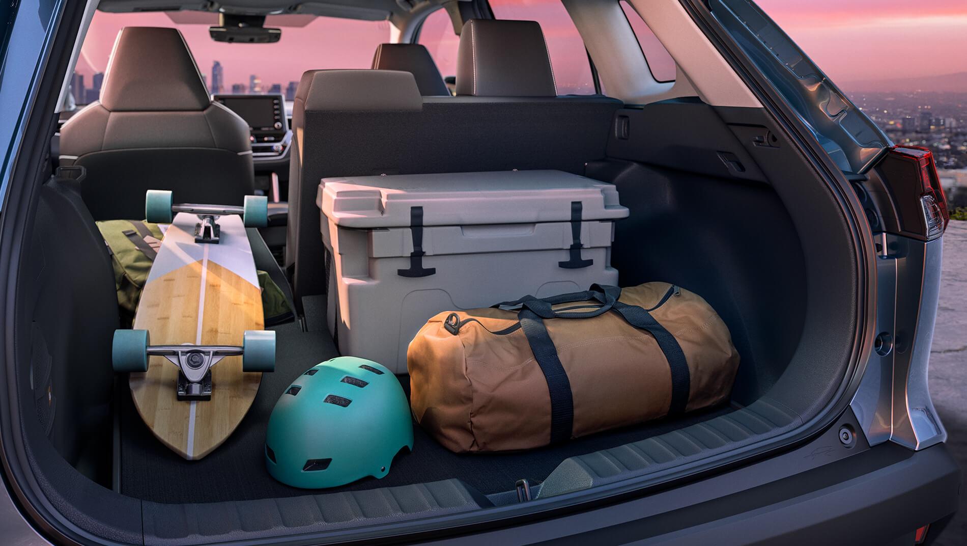 Toyota Corolla Cross large cargo area holds cooler, skateboard, and bag