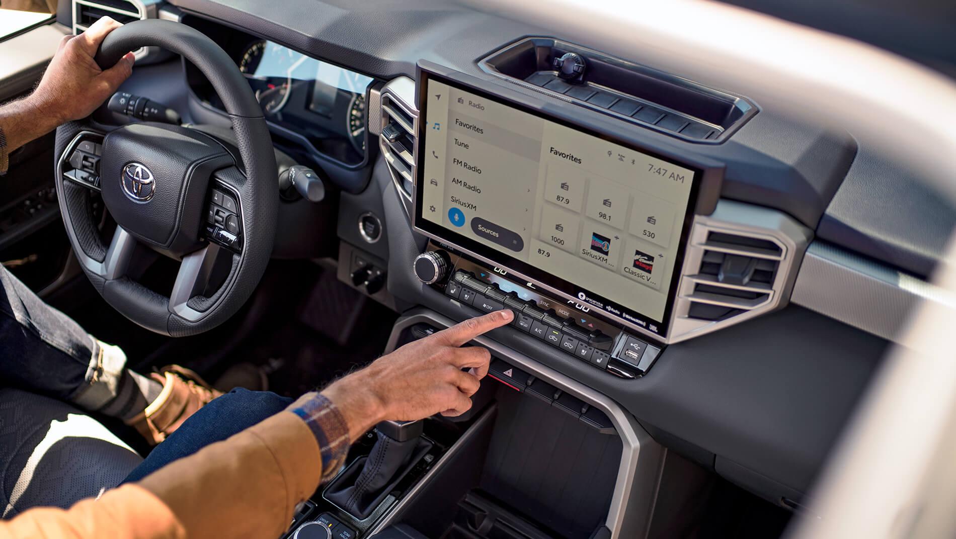 man using the large touch screen in a Toyota Tundra