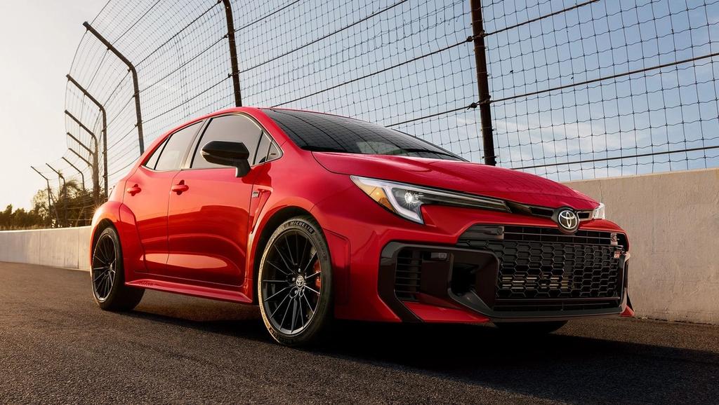 A red Toyota camry sedan with black accents, sporty alloy wheels, and tinted windows