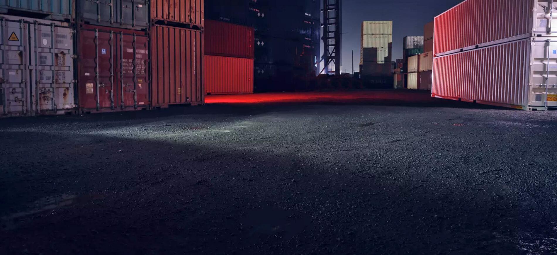 empty shipping yard at night with red lighting