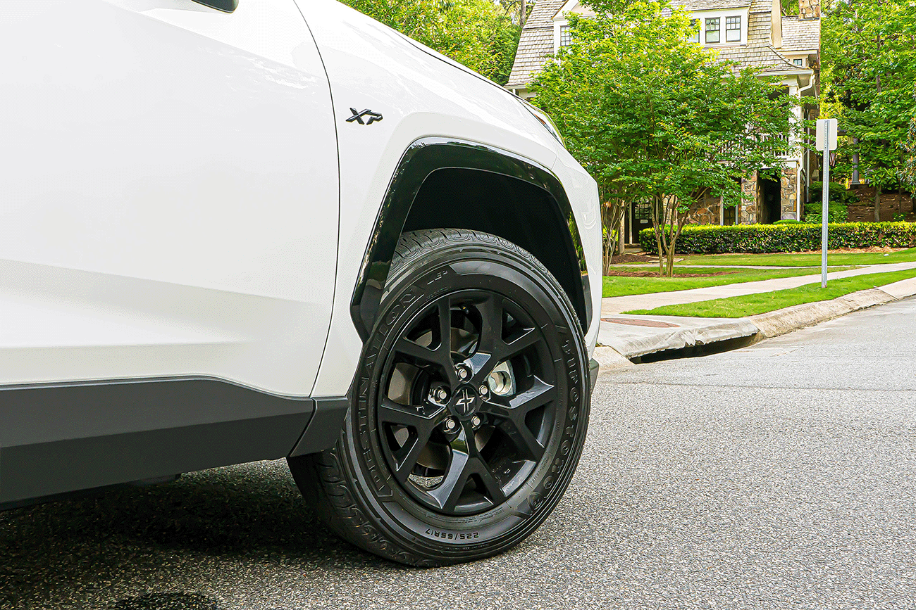 close up of a white Toyota Highlander XP XSeries upgraded accessory package showing the upgraded TRD Wheels
