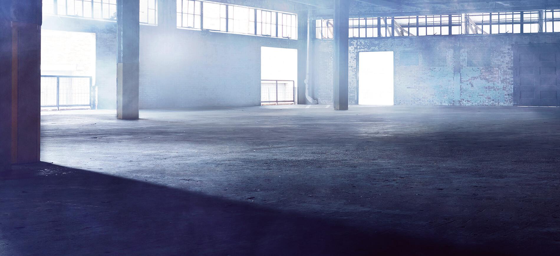 empty warehouse with light streaming in windows