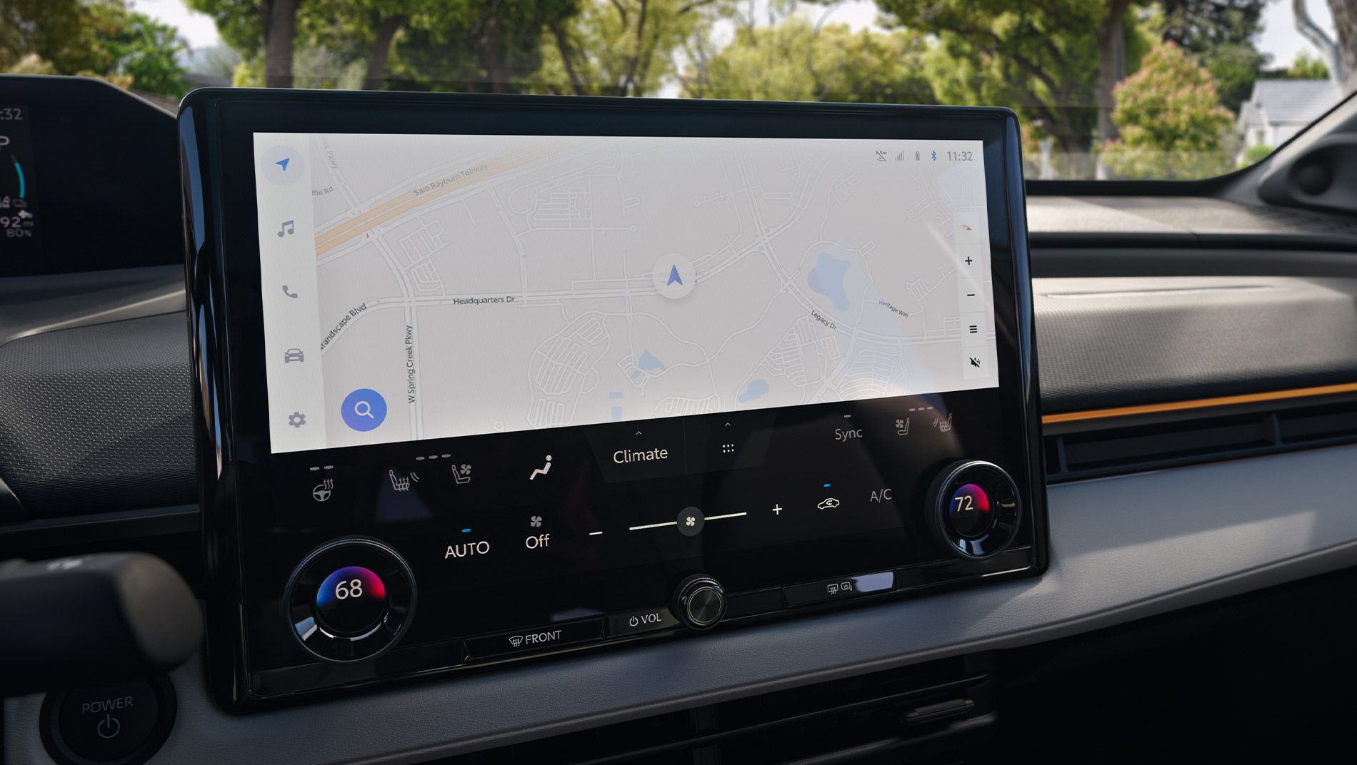 A car dashboard showing a large touchscreen display with a navigation map and climate control settings, including temperature dials set to 68°F and 72°F.