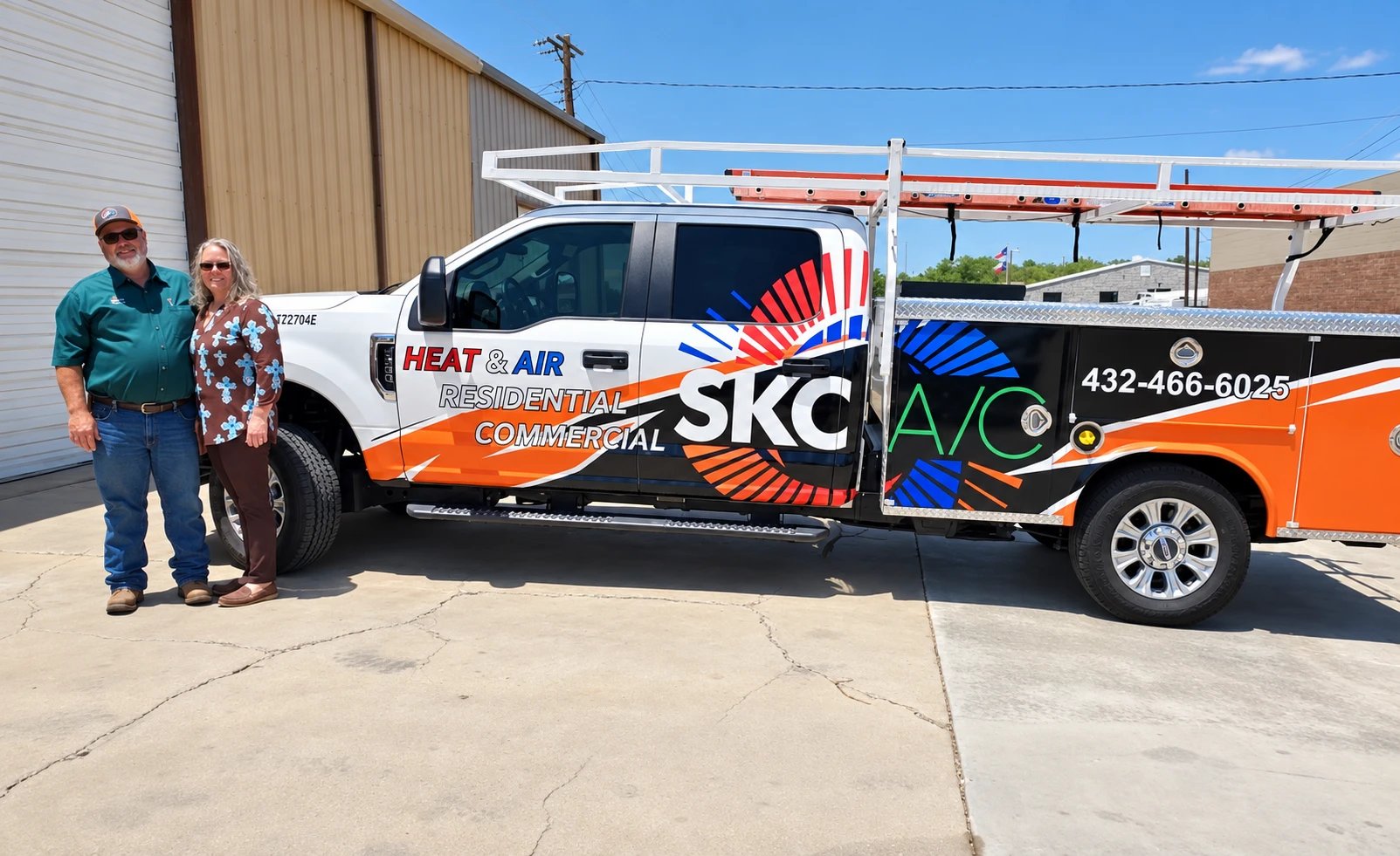 The SKC Heat & Air service truck, lettered Residential and Commercial, with two people standing beside it