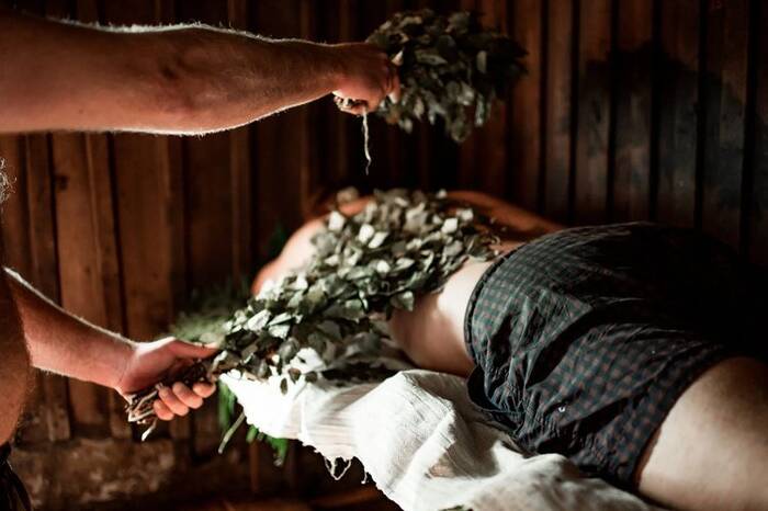 A sauna ritual with birch whisks