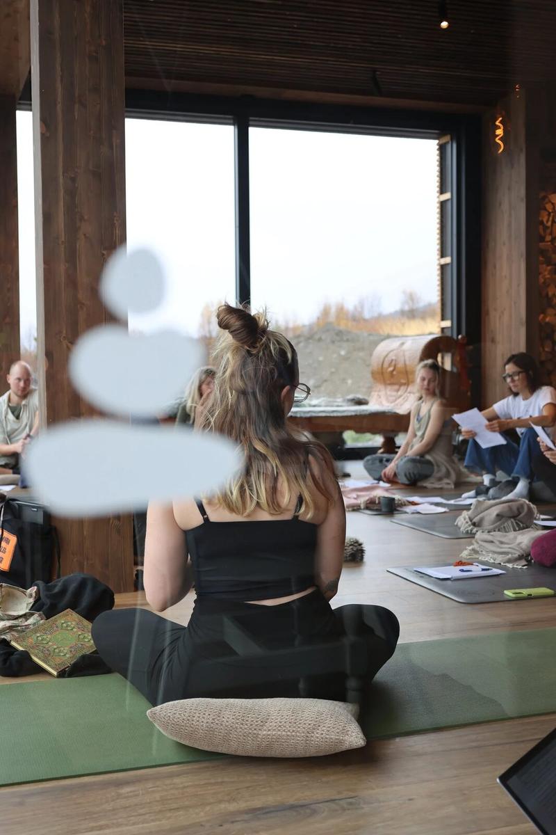A student resting on her mat by the window
