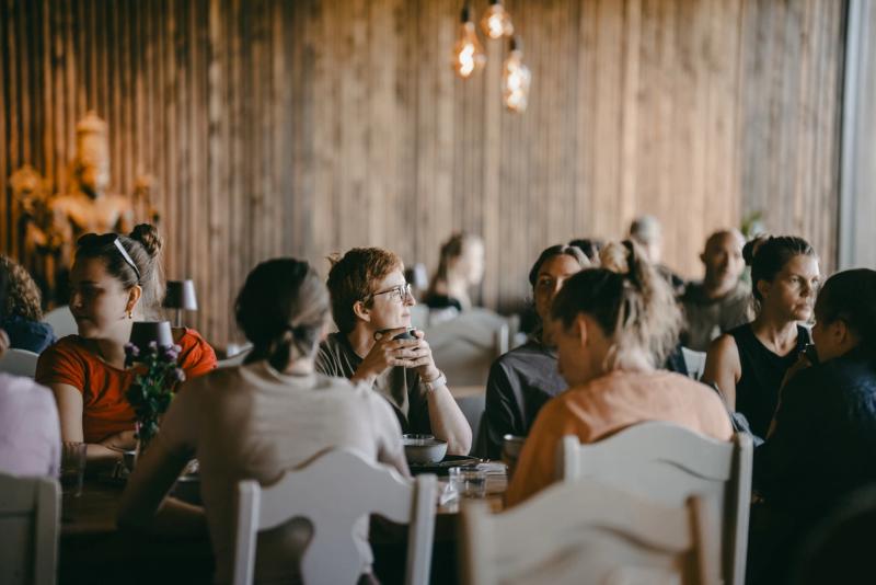 Guests at the long tables in the dining hall