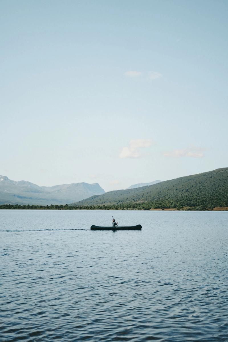 A canoe alone on the lake under the hills