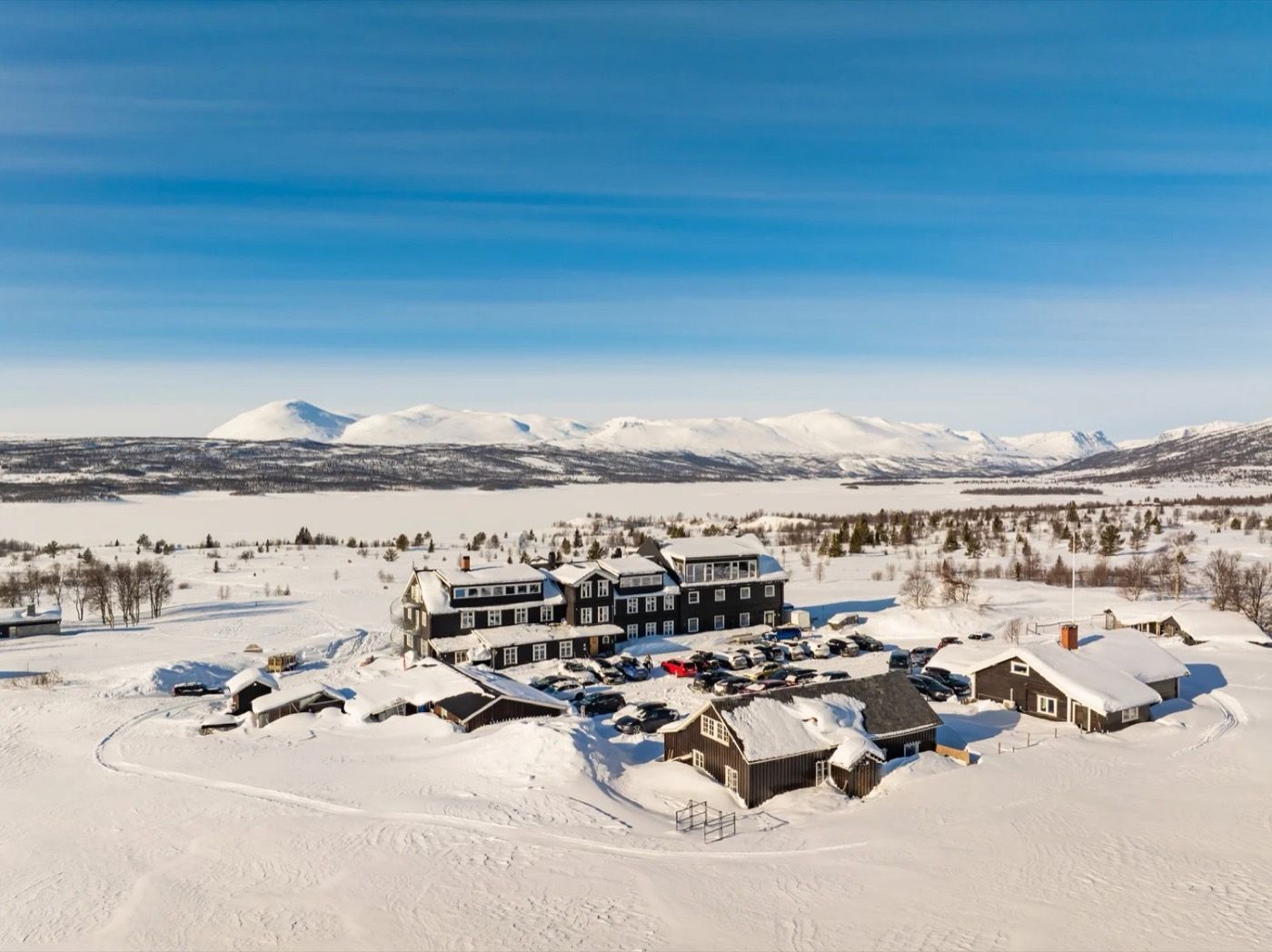 Aerial view of Nøsen in winter, with snow-covered mountains behind