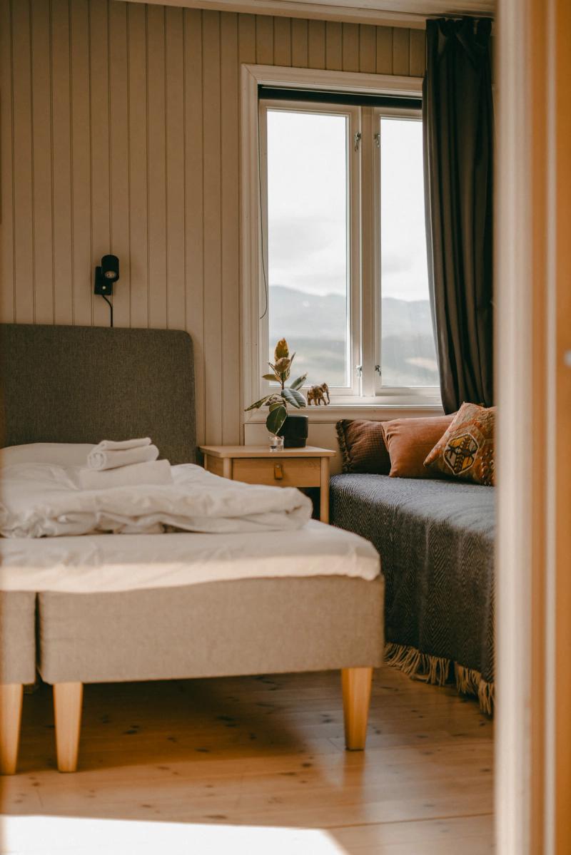 A room with twin beds and the mountains through the window