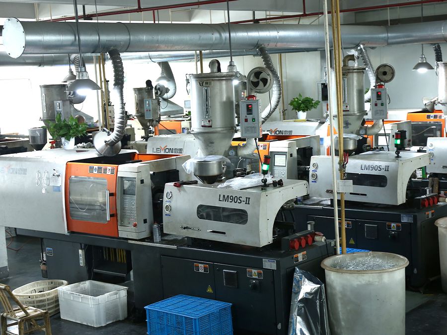 Injection molding equipment used for sunglasses frame production at the DOMI factory