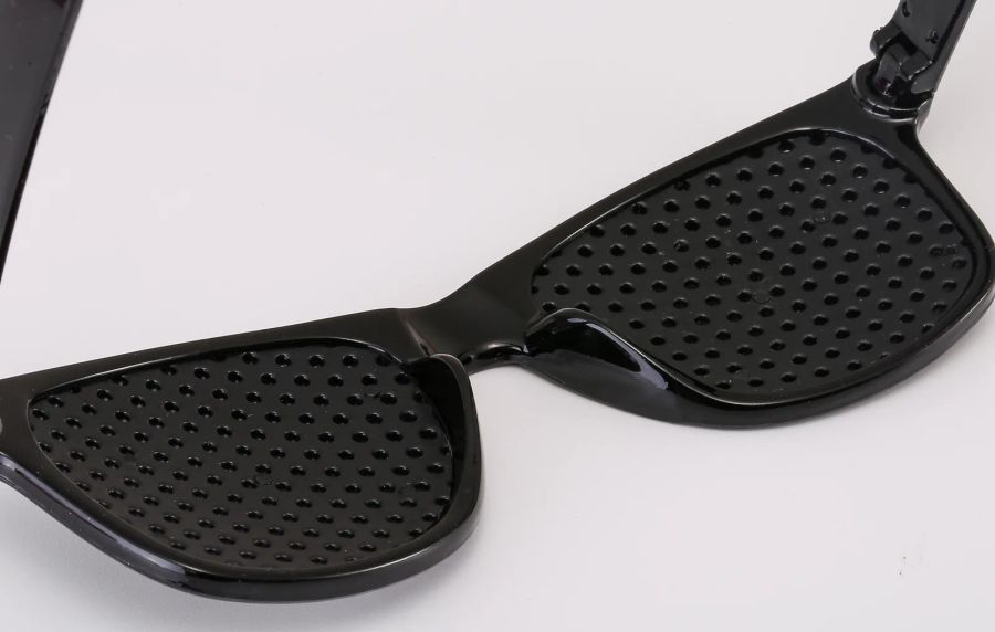 Full perforated front-panel detail on custom pinhole sunglasses DM-580