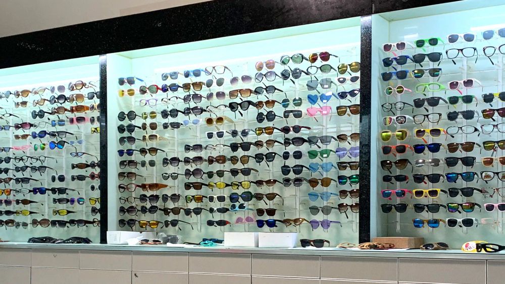 Wall display of assorted sunglasses in the DOMI Eyewear showroom