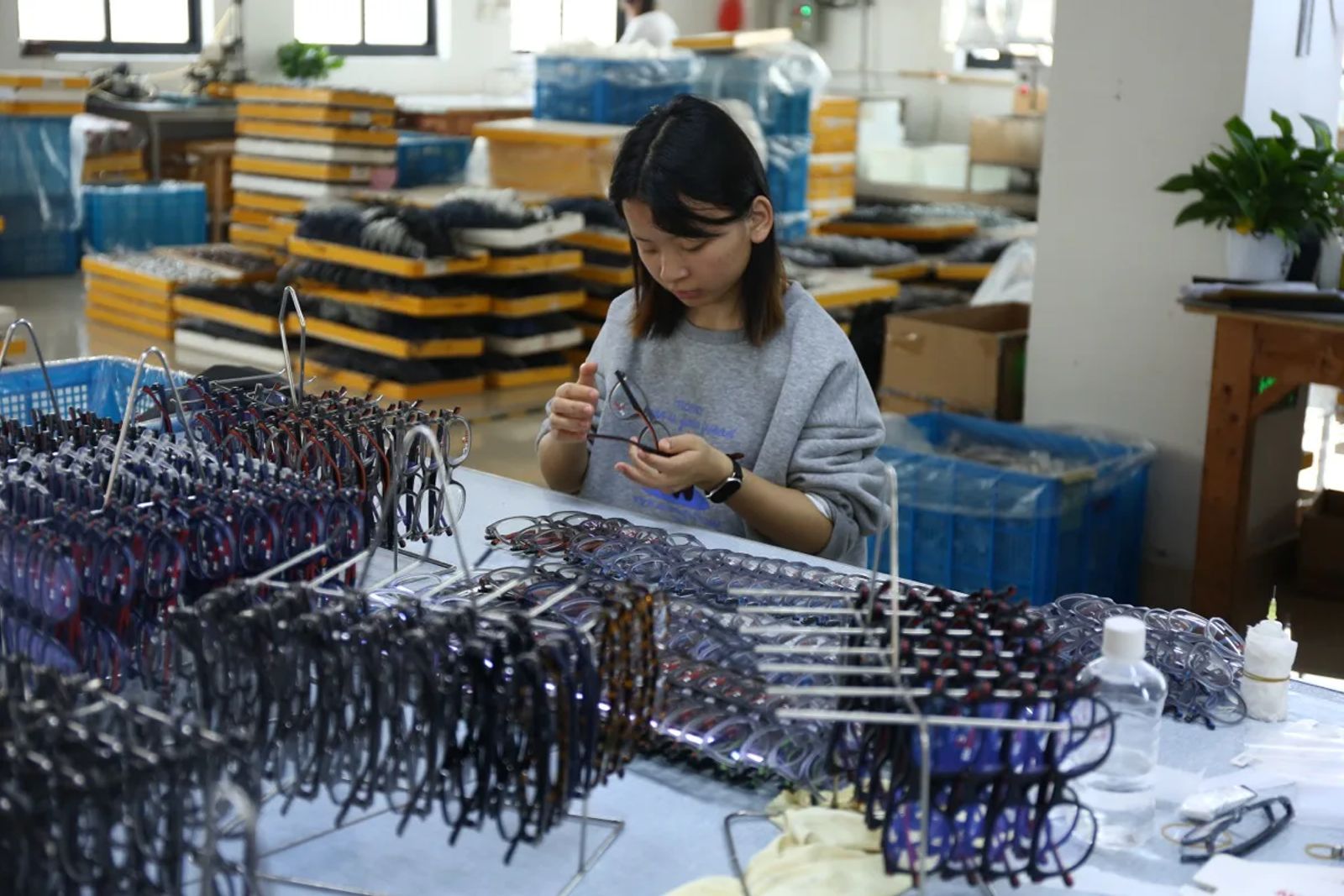 DOMI eyewear inspector checking sunglasses during production