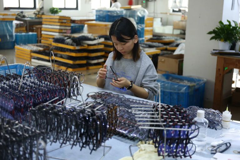 Manual quality inspection of sunglasses frames at DOMI