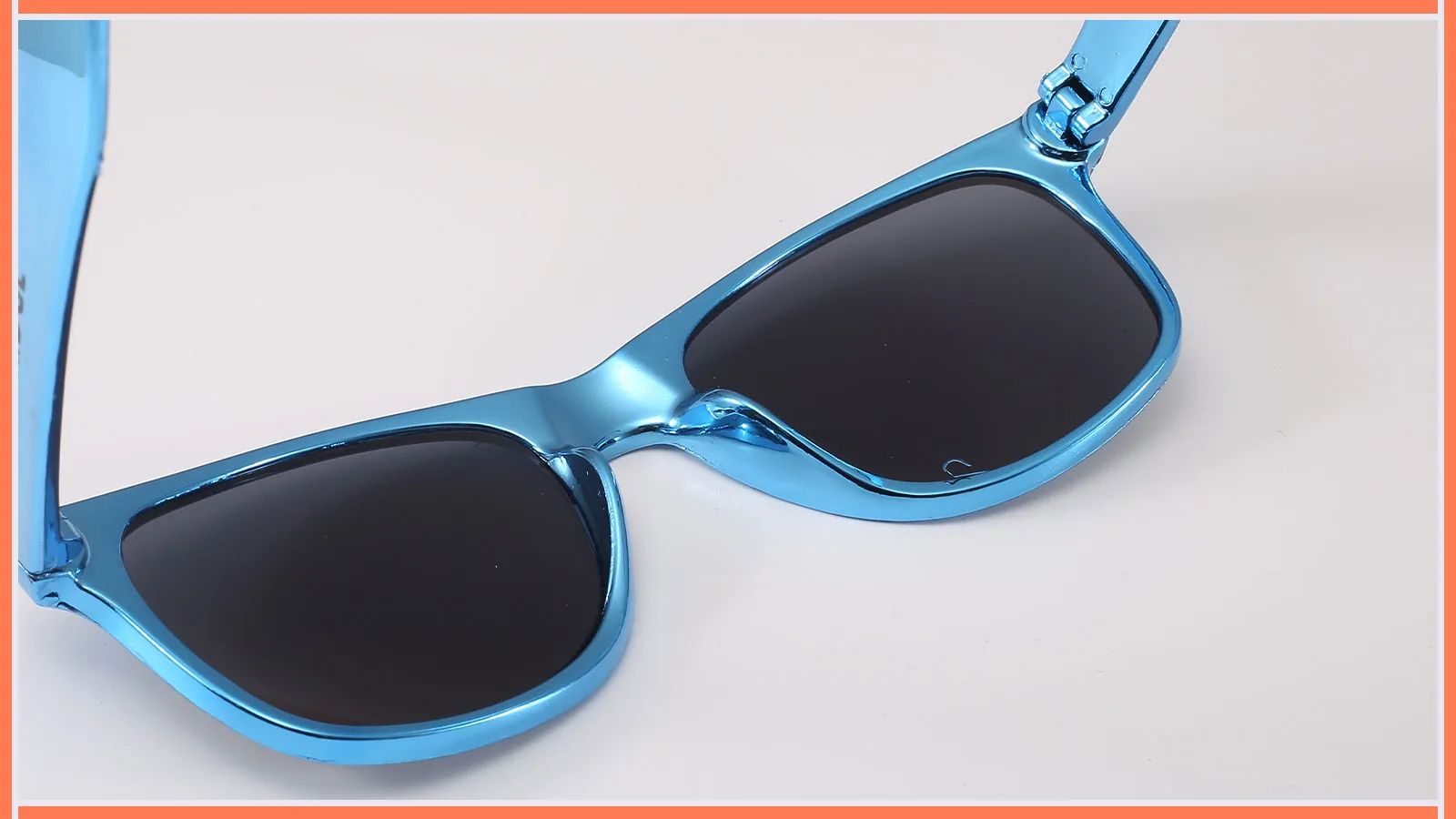 Close-up of blue sunglasses showing frame and lens areas reviewed during defect classification